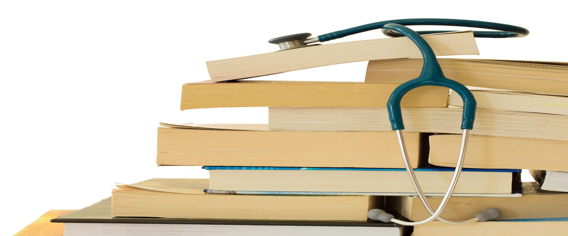 A stethoscope resting on a stack of text books