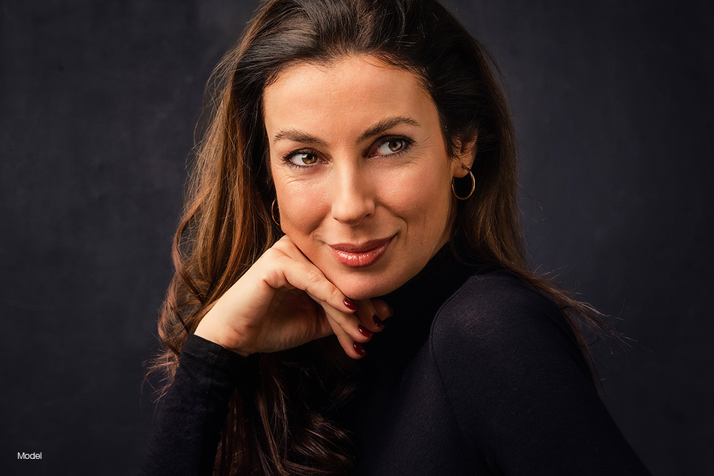Mature woman with her hand on her chin